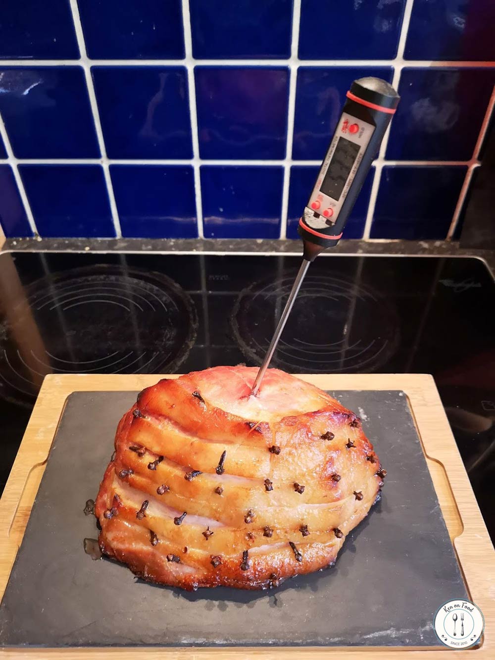 Temperature checking a roast ham from the oven.