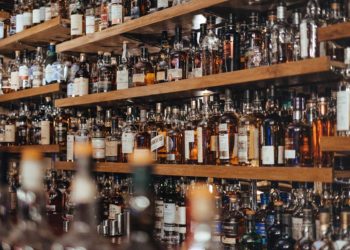 Bottles of spirits on a pub shelf. Photo: Adam Wilson/Unsplash