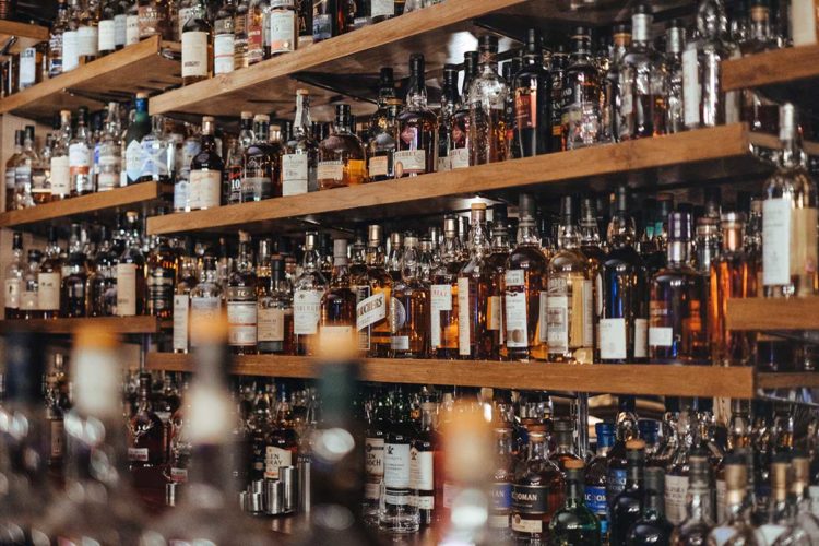 Bottles of spirits on a pub shelf. Photo: Adam Wilson/Unsplash