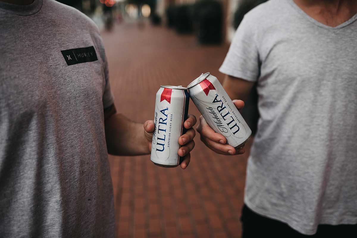 Cans of beer on a street. Photo: Camylla Battani/Unsplash