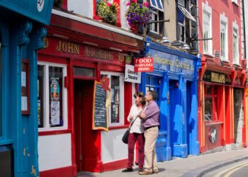 A couple outside John Cleere's, Parliament Street, Kilkenny. Photo: Brian Morrison/Tourism Ireland