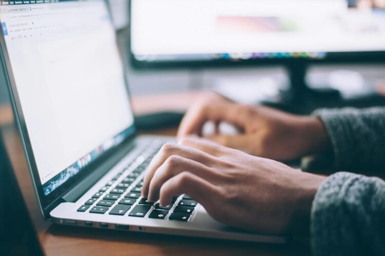 Blogging at a laptop.